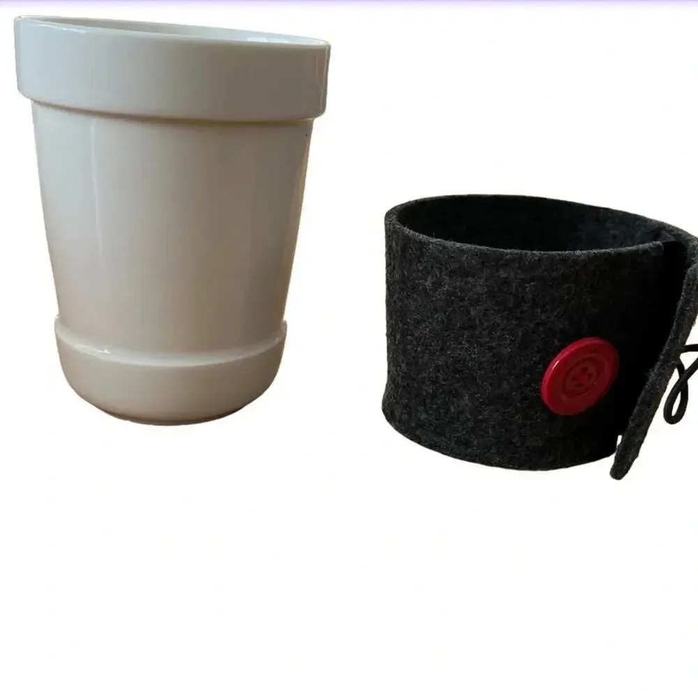 Starbucks 14oz hot beverage mug. The mug has grey felt koozie.